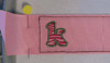 Picture of the stitched #520_SM_1RibbonTemp design with a "k" from our Zebra Filled Font as an example [no font is included in this set].