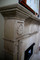 This stone fireplace mantel has been antiqued