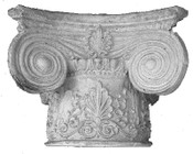 This cast column capital features acanthus leaf frieze and large volutes