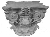 This round cast gypsum column capital features acanthus leaves and corner volutes with a round base
