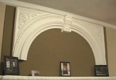 A plaster arched overmantel featuring Acanthus Leaves and Egg and Dart molding