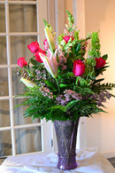 Hot Pink roses, Pink lilies, Bells of irealnd, White snapdragons in a purple vase