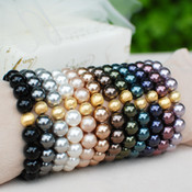 Pearl Stretch Bracelets shown in (left to right) Mystic Black, Dark Gray, White, Powder Almond, Bronze, Brown, Dark Green, Tahitian-Look, Dark Purple, Burgundy, Mauve.