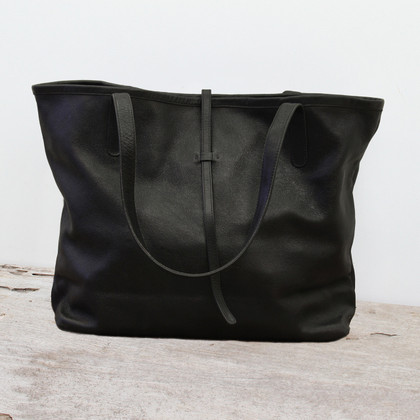 black leather tote bag with minimalist closure black leather tote bag with minimalist closure