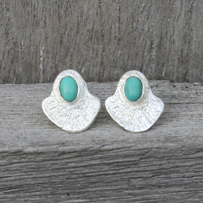 silver plated brass textured studs with a bold bezel and turquoise stone detail silver plated brass textured studs with a bold bezel and turquoise stone detail