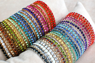 Silver & Gold Swarovski Crystal Stretch Bracelets in (left to right) Light Siam, Hyacinth, Padparadscha, Fuchsia, Rose, Purple Velvet, Tanzanite, Aquamarine, Montana, Sapphire, Zircon, Peridot, Light Topaz, Olivine, Dorado*, Light Colorado Topaz, Smoky Topaz, Crystal (Clear), White Opal**, Black Diamond**, Jet (Black) *Not available in Silver. **Not available in Gold.