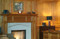 Our Orland wood mantel in Cherry, combined with our limestone Tudor surround and a limestone facing set