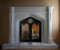 The Gothic Stone Mantel in two sizes. Trefoil design in the spandrels. Wrought iron doors not included.