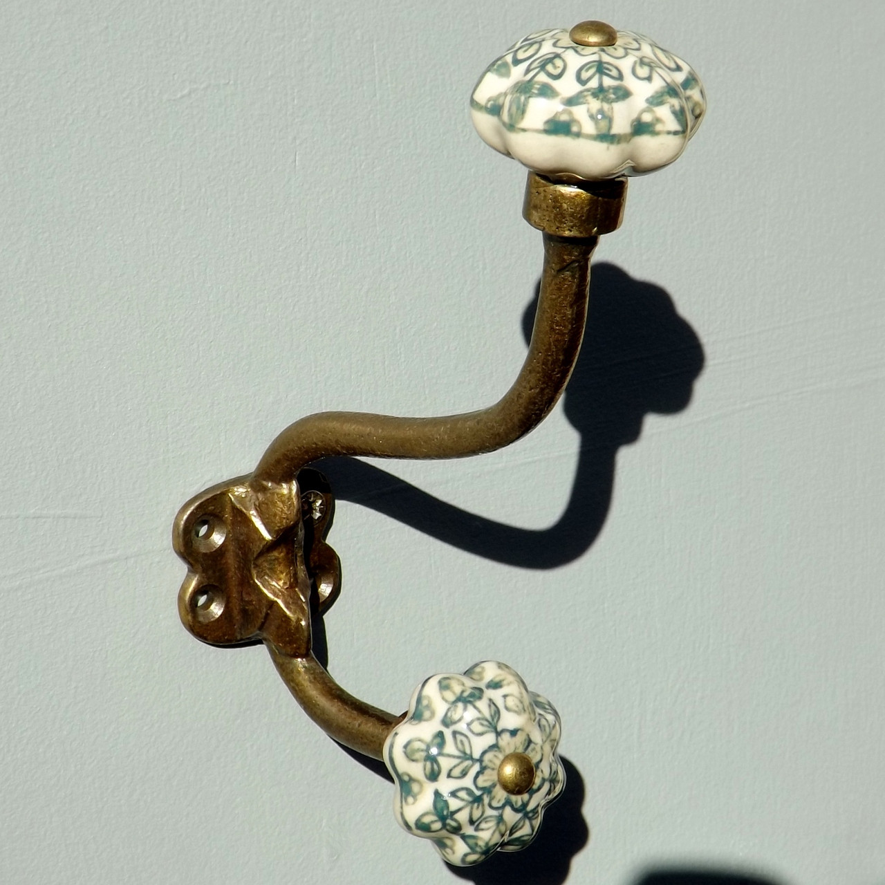 lovehooks.co.uk antique brass effect double coat hook with ceramic knobs