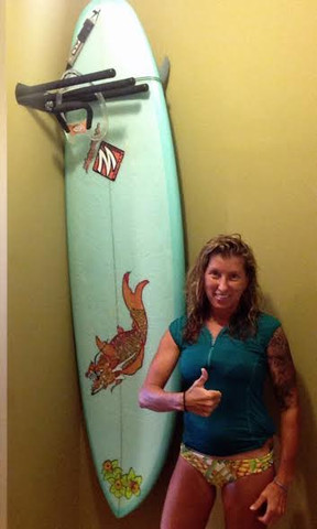 Awesome Kellie right after she mounted her Hang'em High Double surf rack.
She mounted these wall racks in her home
and they fit nicely in the tight spot she had available. 