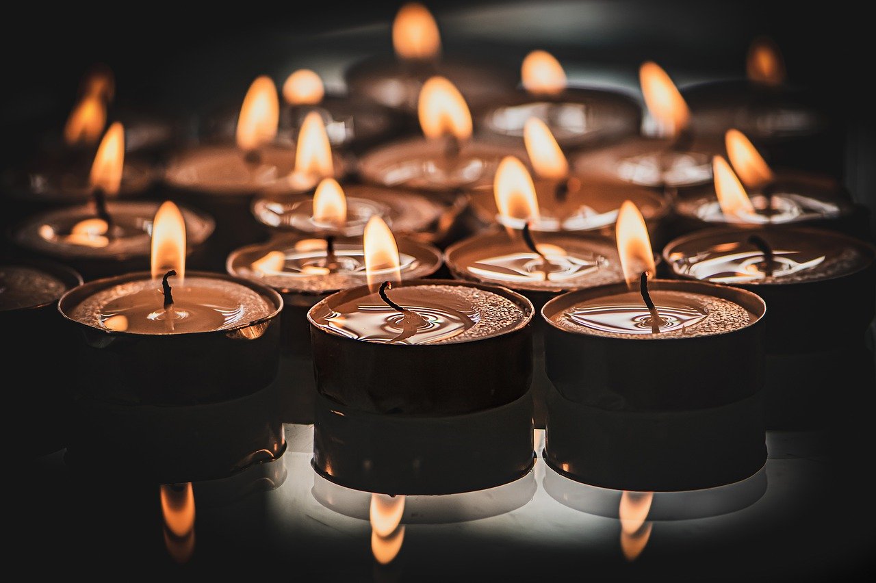 A beautiful image showing several lit candles with a dark background.