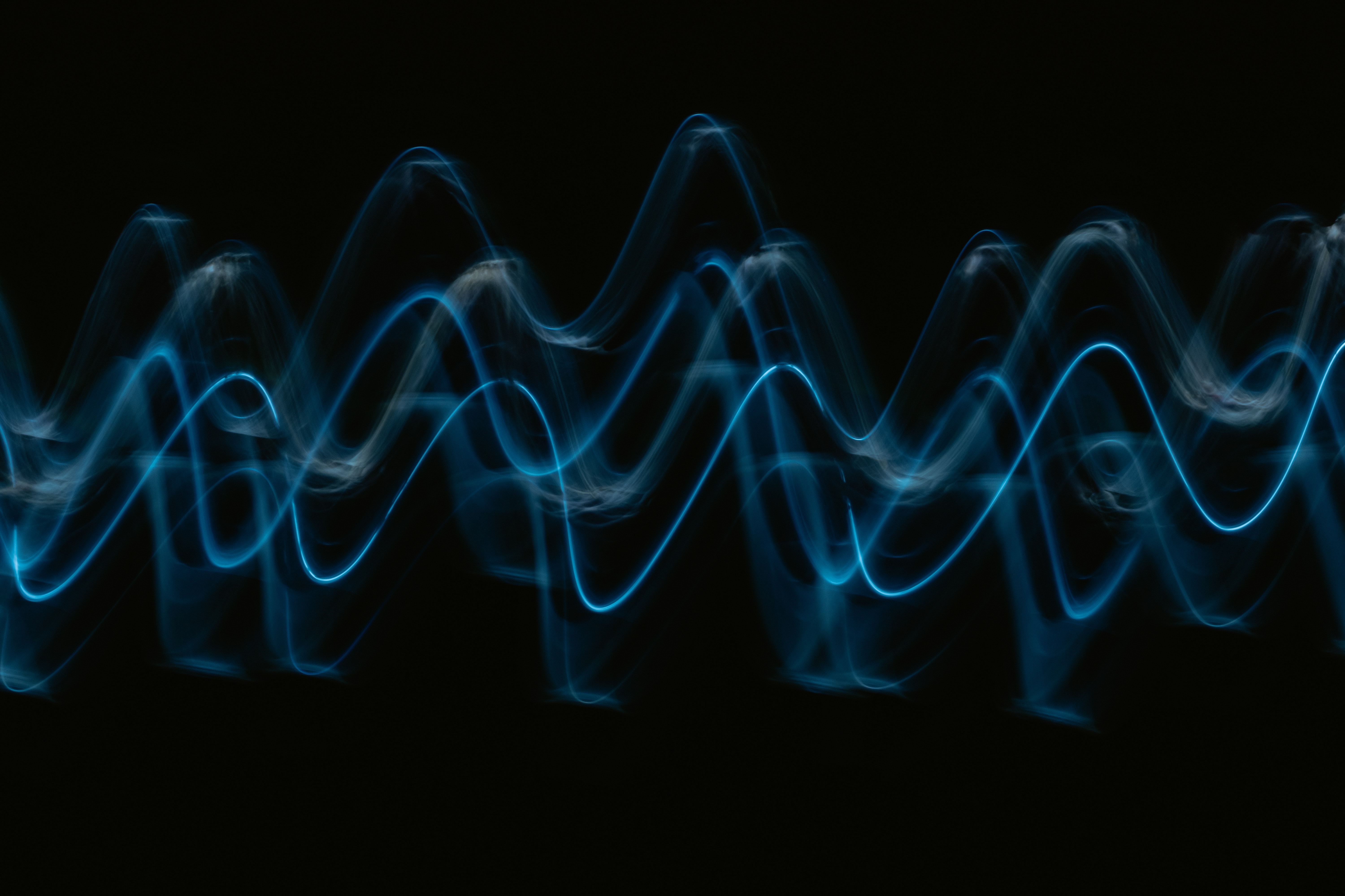 Colorful audio waves pulse with frequencies.