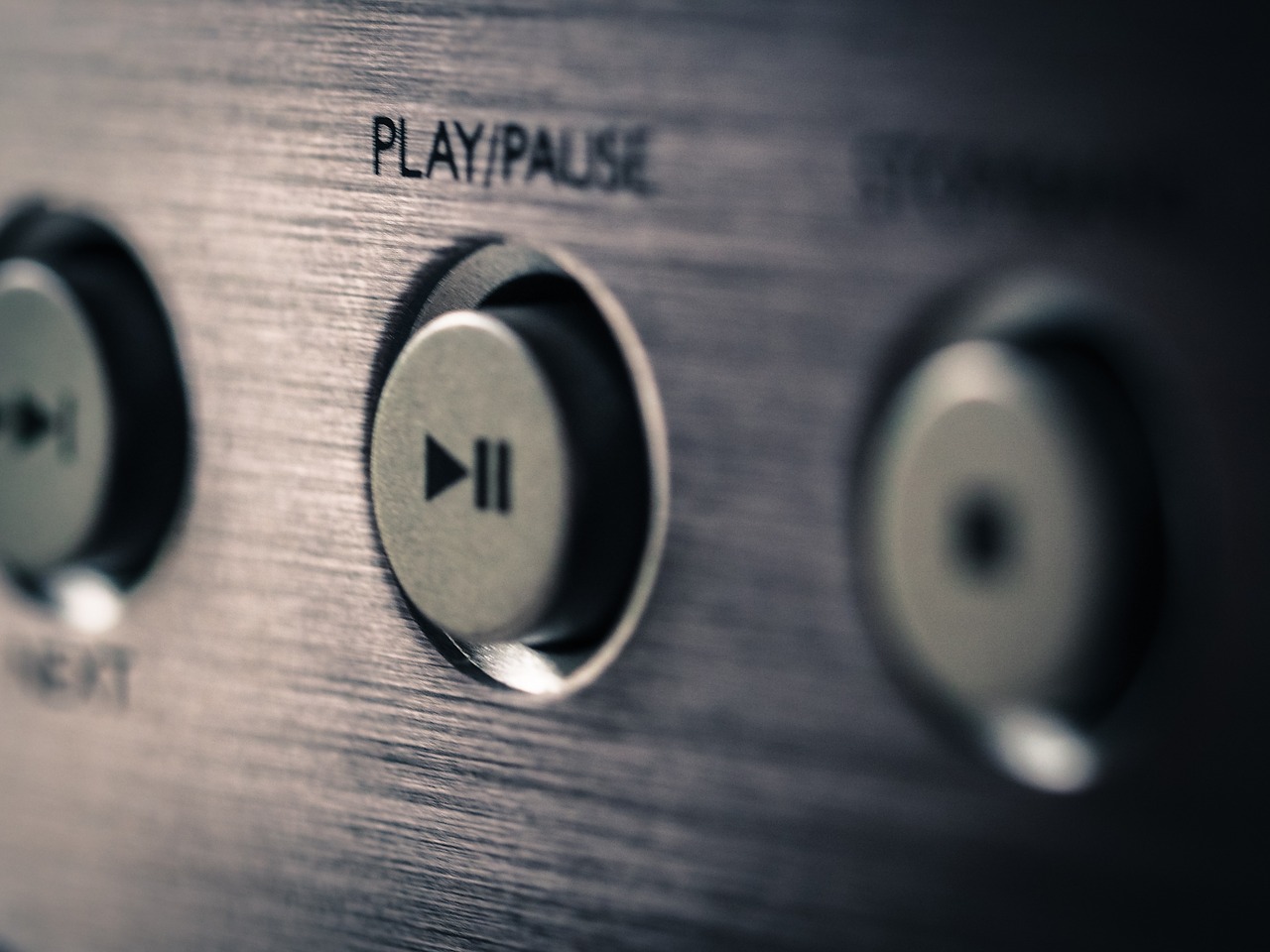 Close up shot of an audio device with a focus on the play button.