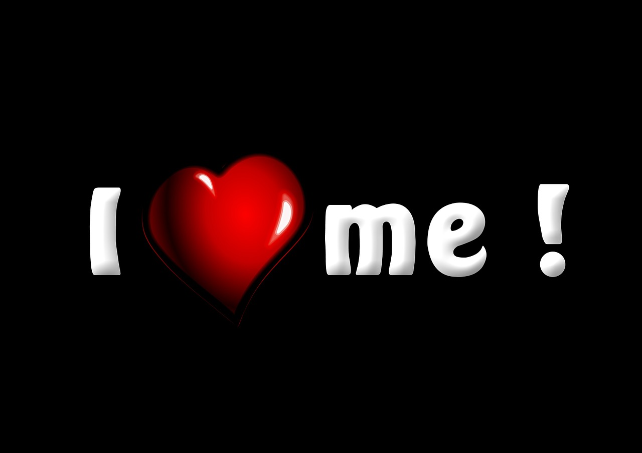 The positive affirmation “I love me” written on a black background. 
