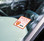 Image shows a numbered parking permit window decal displayed on an automobile windshield.