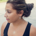Model wearing runner girl circle earrings.
