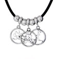3 circle cutout charms on a black cord necklace with sterling silver spacer beads. Each charm is on a dainty charm carrier.