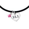 Mini charm cord necklace with pink crystal on a rubber cord