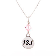 13.1 round charm with a pink crystal on a box chain necklace.