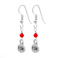 side view of sterling silver 10K dangle earrings with a red crystal.
