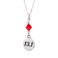 13.1 round charm with red crystal on a sterling silver box chain.