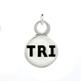Round sterling silver charm with the letters TRI in black.