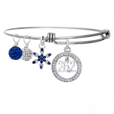 26.2 Cubic Zirconia encircled pendant on an adjustable bangle bracelet with a sapphire studded snowflake and clear and blue pave beads.  