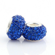 Dark Sapphire Crystal Euroepan beads beside each other. 