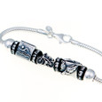 Close up of bracelet with swim bead, bike bead and run beads.