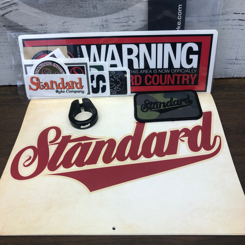 Black seat post clamp, assorted sticker pack, patch, 2026 calendar. 