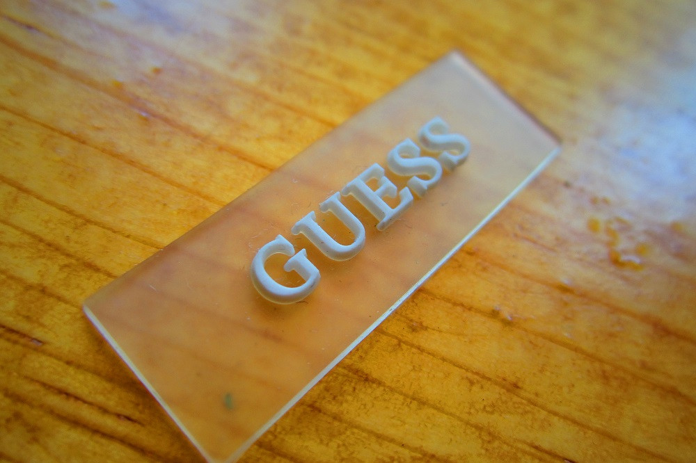 Clear base PVC clothing label, sew down.