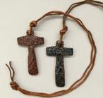 Necklaces are shown here in cross design with upcycled leather. 
