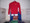 Shown here in a mens 9 oz. 50/50 cotton-blend red with a gold/white service mark.