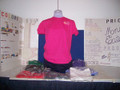 Shown here is an embroidered 5.3 oz heliconia (dark pink) cotton T-shirt and very beautifully simple. Product note: Vinyl heat transfer option is similar to screen-printing with the same great aesthetic and durability just a slightly different process.