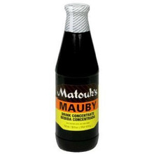 Matouk's Mauby Concentrate 26oz packaged in a glass bottle with Yellow and Orange labeling 