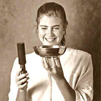 Annette playing an antique Tibetan singing bowl by stricking on it's upper lip