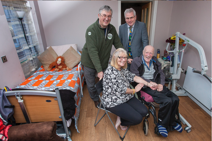 A former postman struck down by motor neurone disease has been helped to stay in his home, thanks to their local MP and Flintshire building firm Rubicon Garden Rooms.