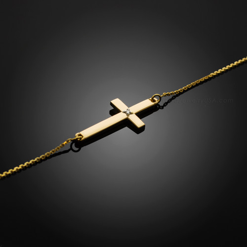 gold sideways cross bracelet with a diamond
