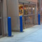 Base Plated Bollards with Blue Bollard Covers protecting a retail store