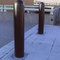 Base Plated Bollards with Black Bollard Covers at a Parking Garage