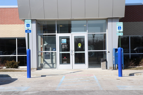 Blue Heavy Duty Sign Bollards lining a bank storefront 