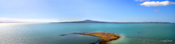Rangitoto, reef and blue water, landscape photograph from St. Heliers, Auckland - print for sale.