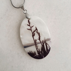 Silhouetted flax pendant necklace.