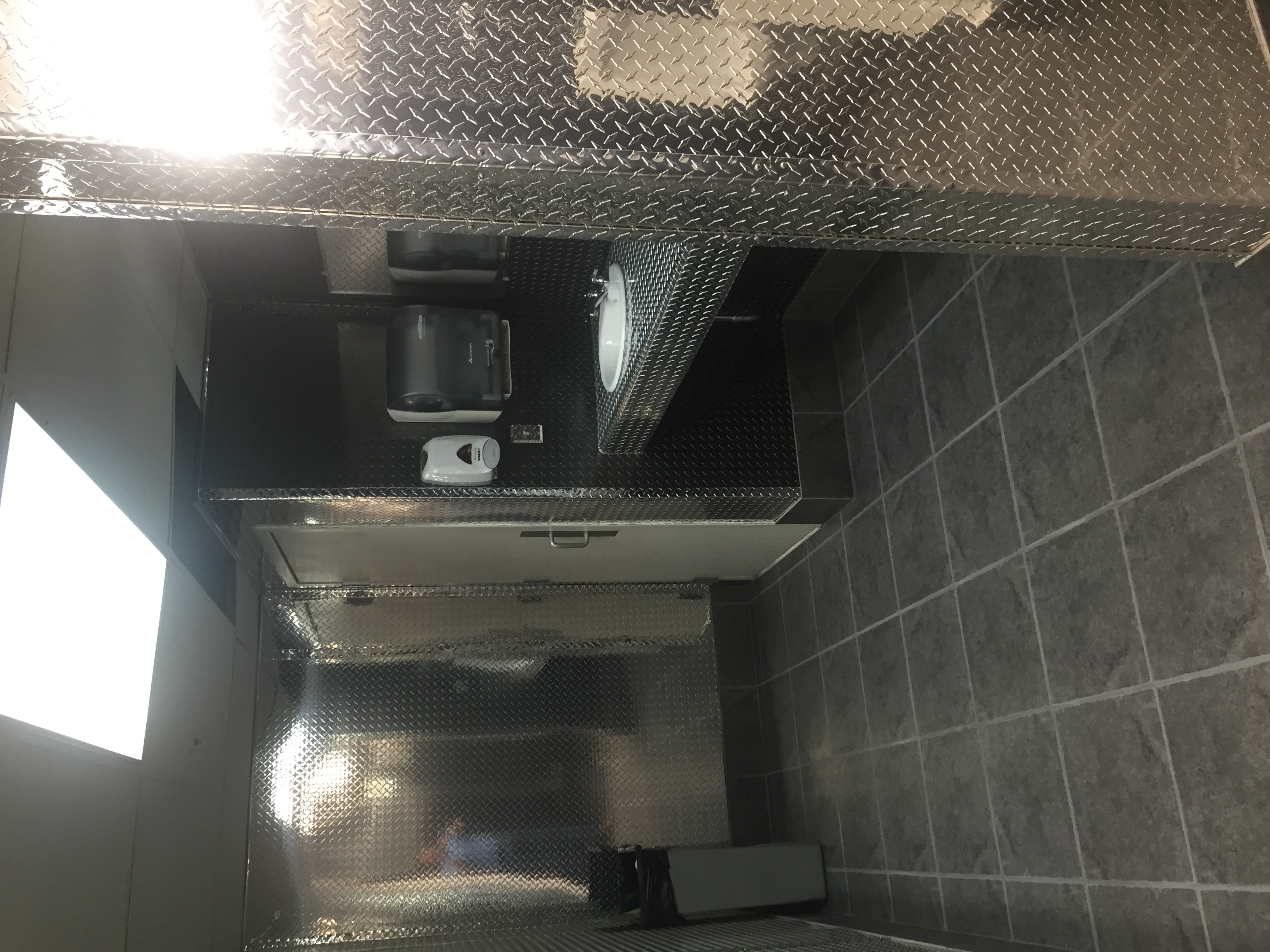 Commercial bathroom using diamond plate wall panels from CutsMetal
