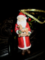 Vintage Style German Christmas Santa Claus hanging ornament holding toy horse.