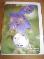 Greetings card with meadow cranesbill seeds