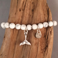 WHITE HOWLITE BEAD BRACELET, WITH A FISHING LURE AND WHALE TAIL CHARM. 
BRACELET STRETCHES