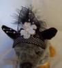 PB. Black mesh, with white flower, feathers and ribbon
