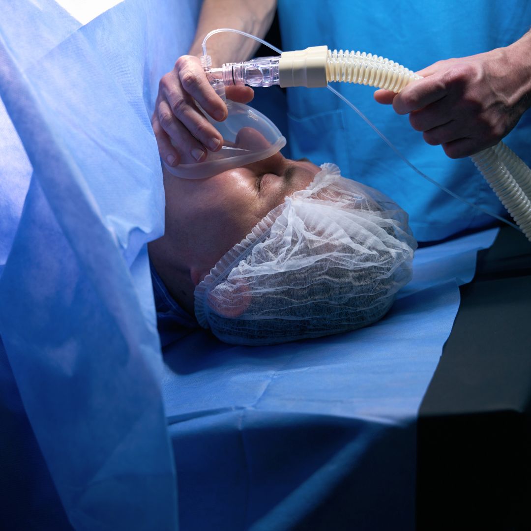 A woman under anesthesia on an operating table