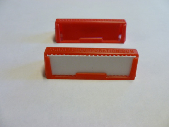 Label holder clips to a box or clips two boxes together